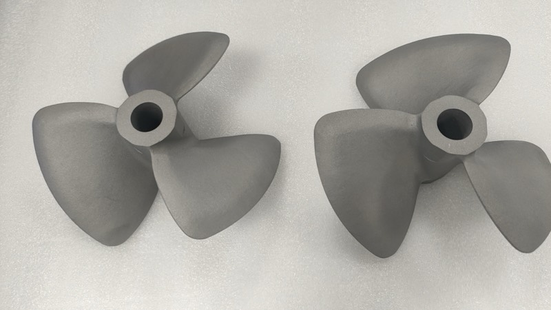 Two metal 3D-printed boat propellers, bead-blasted finish — Part manufactured by INNOPRODUCT World