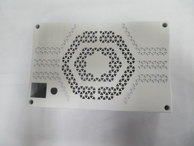 White 3D-printed enclosure lid with hexagonal perforation pattern — 3D printing