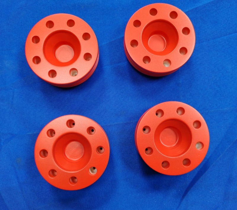 Red anodised aluminium turned flanges — CNC machining