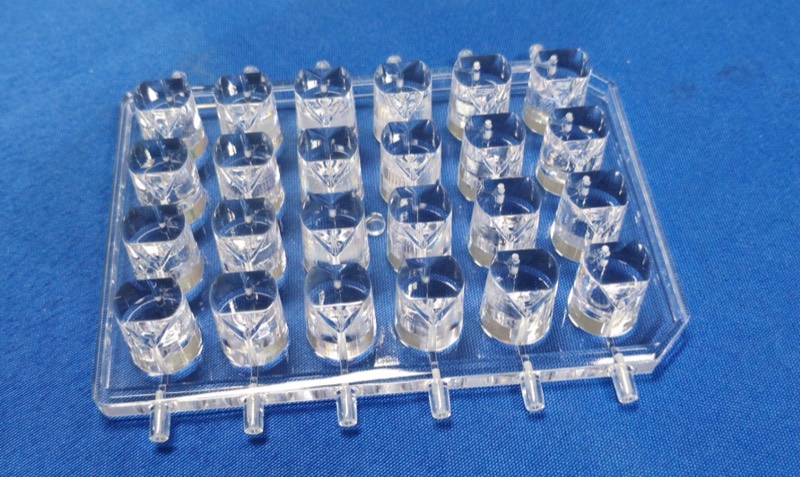 Clear injection-moulded lens array on its runner — Part manufactured by INNOPRODUCT World