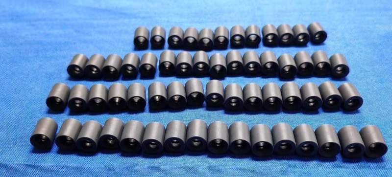 Series of black injection-moulded sleeves — Injection moulding