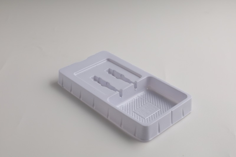 White thermoformed plastic tray with fitted cavities — Thermoforming