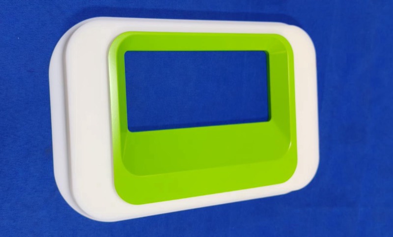 White housing with lime-green painted bezel, vacuum cast — Vacuum casting